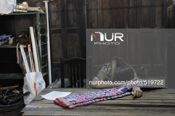 Sandhya - a resident who lives close by hiding her face from the camera after she came in to pick up a "sari" which she booked before the au...