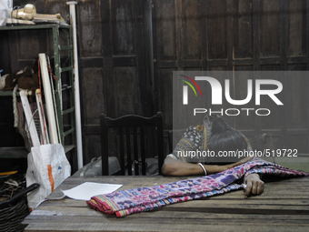 Sandhya - a resident who lives close by hiding her face from the camera after she came in to pick up a "sari" which she booked before the au...