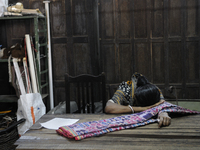 Sandhya - a resident who lives close by hiding her face from the camera after she came in to pick up a "sari" which she booked before the au...