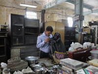 Tarun chatterjee who works as a security guard nearby checking stuff to be auctioned tomorrow at The Russell Exchange on Saturday a day prio...