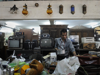 A customer checking items to be auctioned  tomorrow  at The Russell Exchange on Saturday a day prior to the sunday auction on 4th April , 20...