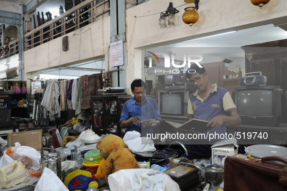 Mr . Ayub ( R) along with his friend checking items to be auctioned on sunday  at The Russell Exchange on Saturday a day prior to the sunday...