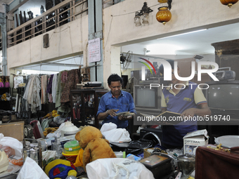 Mr . Ayub ( R) along with his friend checking items to be auctioned on sunday  at The Russell Exchange on Saturday a day prior to the sunday...