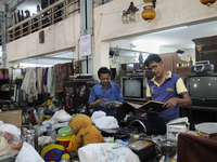 Mr . Ayub ( R) along with his friend checking items to be auctioned on sunday  at The Russell Exchange on Saturday a day prior to the sunday...