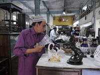 Mr. Yakub who is a supplier cleaning items on Saturday a day prior to the sunday auction on 4th April , 2015 in Kolkata, India.The Russell E...