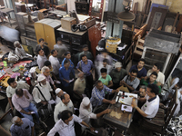 Sheikh Samsuddinan the auctioneer being circled by bidders during the Auction at The Russell Exchange on 5th April , 2015 in Kolkata, India....