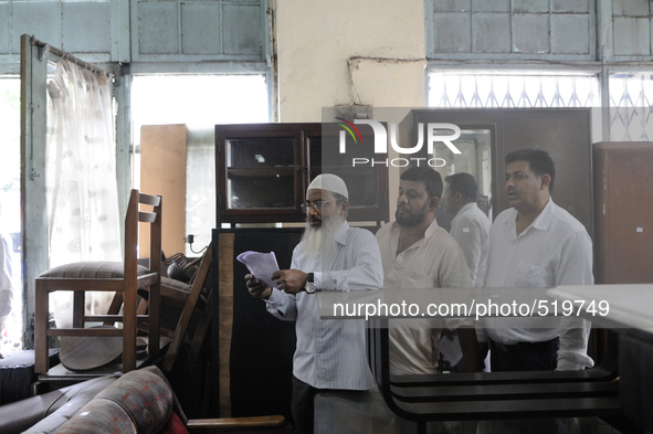 Mr.Riyaz (L) along with his associates looking through the check list ( the piece of computer generated piece of paper used every week) duri...