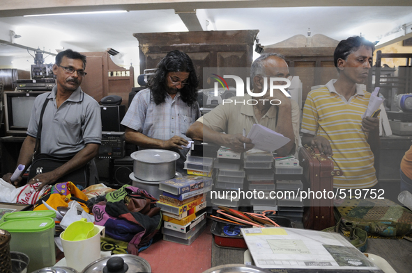 Babloo (Guy with long hair) and Mr. Mondol ( Guy on the left of Babloo) watch closely the items to auctioned during the Auction at The Russe...