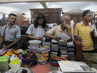 Babloo (Guy with long hair) and Mr. Mondol ( Guy on the left of Babloo) watch closely the items to auctioned during the Auction at The Russe...