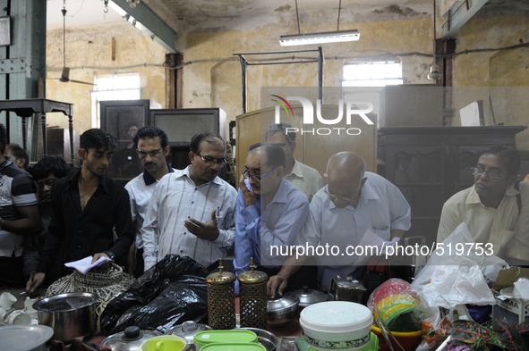 Customers seeing and debating on items put up for auction during the Auction at The Russell Exchange on 5th April , 2015 in Kolkata, India....