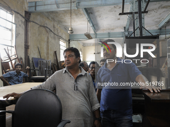 Mr. Ahmed( L) a regular buyer of furniture standing along with Kapil- A porter at The Russell Exchange watching closely the furniture auctio...