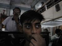 Md Omar(L)-the main auctioneer on that day and Azharuddin(M) both employees of The Russell Exchange watching closely the furniture auction a...