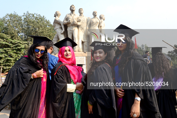 A group of graduates expressing their delight in front of the sculpture Raju at TSC area, on the 52th convocation of the students of Dhaka U...