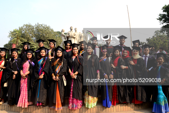 A group of graduates expressing their delight in front of the sculpture Raju at TSC area, on the 52th convocation of the students of Dhaka U...