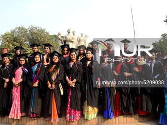 A group of graduates expressing their delight in front of the sculpture Raju at TSC area, on the 52th convocation of the students of Dhaka U...