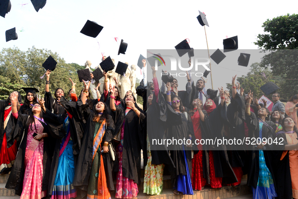 A group of graduates expressing their delight in front of the sculpture Raju at TSC area, on the 52th convocation of the students of Dhaka U...