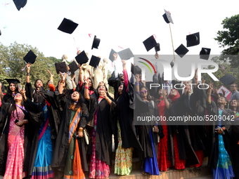 A group of graduates expressing their delight in front of the sculpture Raju at TSC area, on the 52th convocation of the students of Dhaka U...