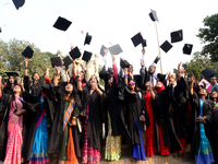 A group of graduates expressing their delight in front of the sculpture Raju at TSC area, on the 52th convocation of the students of Dhaka U...