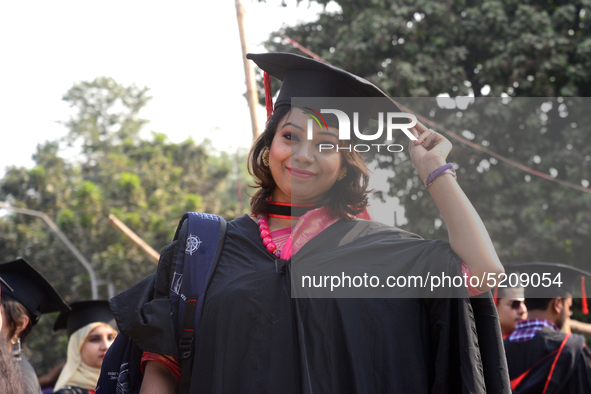 A group of graduates expressing their delight in front of the sculpture Raju at TSC area, on the 52th convocation of the students of Dhaka U...