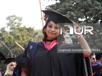 A group of graduates expressing their delight in front of the sculpture Raju at TSC area, on the 52th convocation of the students of Dhaka U...