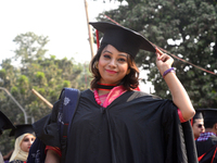 A group of graduates expressing their delight in front of the sculpture Raju at TSC area, on the 52th convocation of the students of Dhaka U...