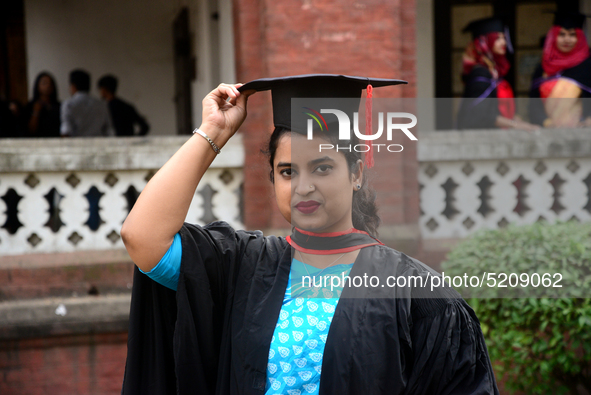 A group of graduates expressing their delight in front of the Curzon hall at university area, on the 52th convocation of the students of Dha...