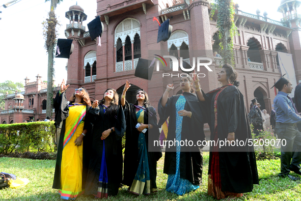 A group of graduates expressing their delight in front of the Curzon hall at university area, on the 52th convocation of the students of Dha...