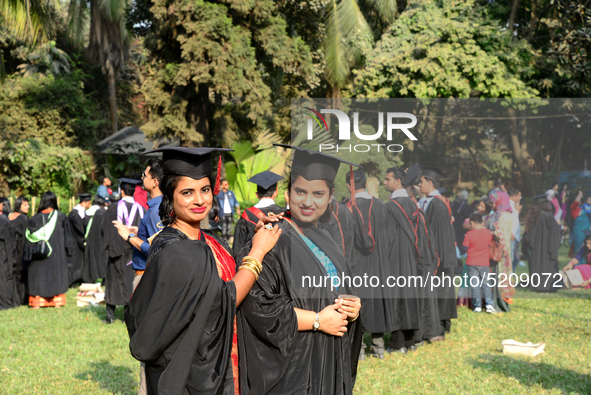 A group of graduates expressing their delight in front of the Curzon hall at university area, on the 52th convocation of the students of Dha...