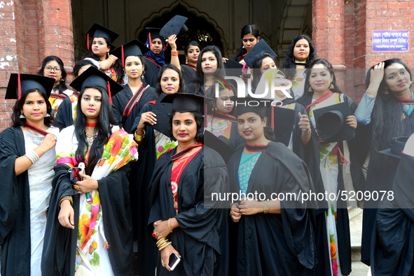 A group of graduates expressing their delight in front of the Curzon hall at university area, on the 52th convocation of the students of Dha...