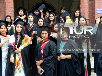 A group of graduates expressing their delight in front of the Curzon hall at university area, on the 52th convocation of the students of Dha...