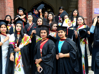 A group of graduates expressing their delight in front of the Curzon hall at university area, on the 52th convocation of the students of Dha...