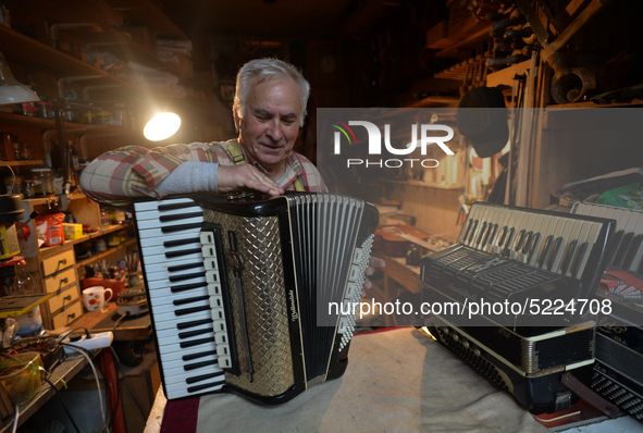 Former theatre actor and long time artist and luthier, Jozef Gmyrek (age 71), tunes an accordion in his workshop.    
His work is not a job...