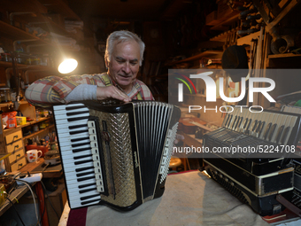 Former theatre actor and long time artist and luthier, Jozef Gmyrek (age 71), tunes an accordion in his workshop.    
His work is not a job...