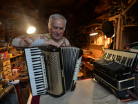 Former theatre actor and long time artist and luthier, Jozef Gmyrek (age 71), tunes an accordion in his workshop.    
His work is not a job...