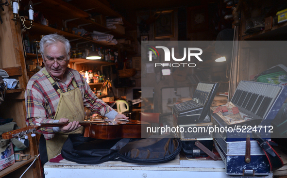 Former theatre actor and long time artist and luthier, Jozef Gmyrek (age 71), tunes a guitar in his workshop.
His work is not a job but a pa...