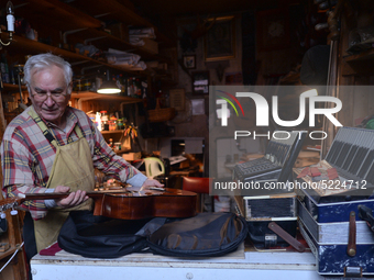 Former theatre actor and long time artist and luthier, Jozef Gmyrek (age 71), tunes a guitar in his workshop.
His work is not a job but a pa...