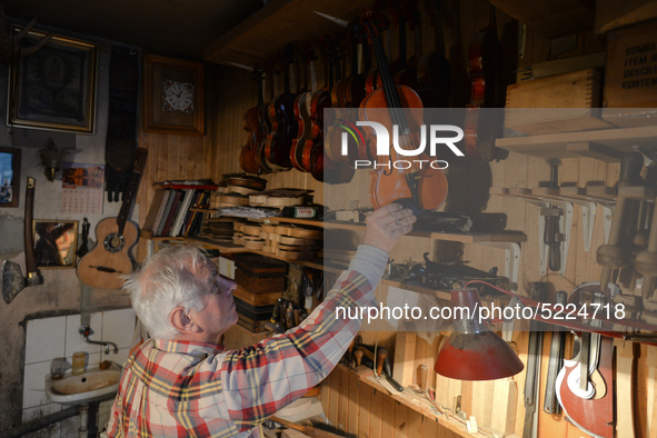 Former theatre actor and long time artist and luthier, Jozef Gmyrek (age 71), holds a violin in his workshop.
His work is not a job but a pa...