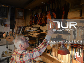 Former theatre actor and long time artist and luthier, Jozef Gmyrek (age 71), holds a violin in his workshop.
His work is not a job but a pa...