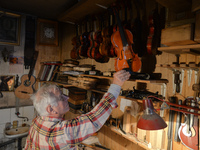 Former theatre actor and long time artist and luthier, Jozef Gmyrek (age 71), holds a violin in his workshop.
His work is not a job but a pa...