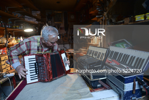 Former theatre actor and long time artist and luthier, Jozef Gmyrek (age 71), tunes an accordion in his workshop.
His work is not a job but...