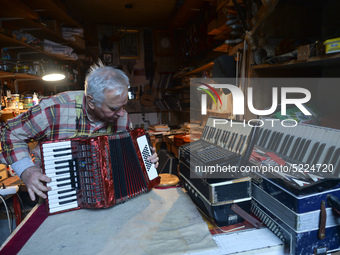 Former theatre actor and long time artist and luthier, Jozef Gmyrek (age 71), tunes an accordion in his workshop.
His work is not a job but...