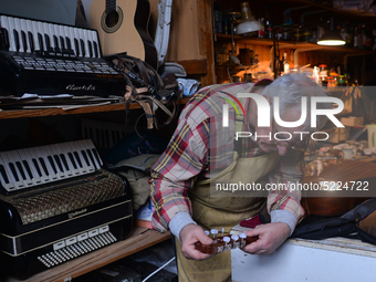 Former theatre actor and long time artist and luthier, Jozef Gmyrek (age 71), tunes a guitar in his workshop. 
His work is not a job but a p...