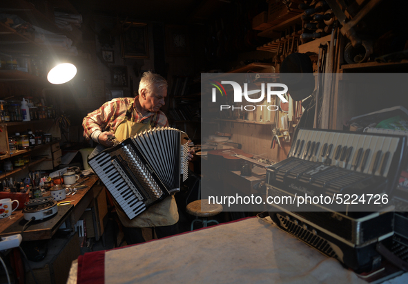 Former theatre actor and long time artist and luthier, Jozef Gmyrek (age 71), tunes an accordion in his workshop.     
His work is not a job...