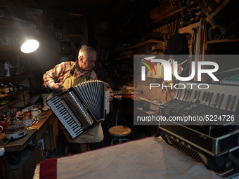 Former theatre actor and long time artist and luthier, Jozef Gmyrek (age 71), tunes an accordion in his workshop.     
His work is not a job...