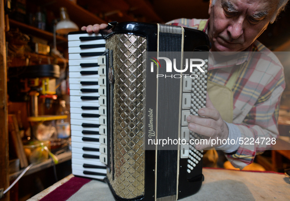 Former theatre actor and long time artist and luthier, Jozef Gmyrek (age 71), tunes an accordion in his workshop.    
His work is not a job...