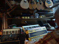 Former theatre actor and long time artist and luthier, Jozef Gmyrek (age 71), holds an antic Settimio Soprani accordion, inside his workshop...