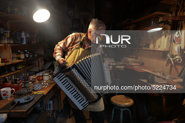 Former theatre actor and long time artist and luthier, Jozef Gmyrek (age 71), tunes an accordion in his workshop.     
His work is not a job...