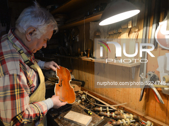 Former theatre actor and long time artist and luthier, Jozef Gmyrek (age 71), repairs a violin in his workshop.  
His work is not a job but...