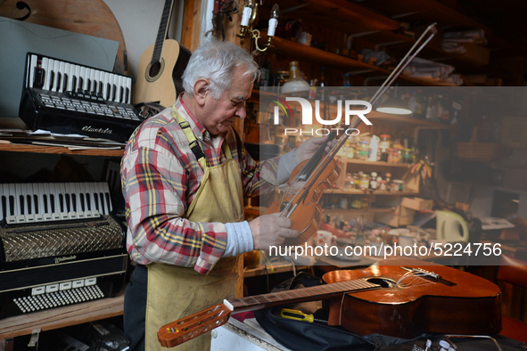 Former theatre actor and long time artist and luthier, Jozef Gmyrek (age 71), tunes a violin in his workshop.
His work is not a job but a pa...