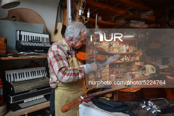 Former theatre actor and long time artist and luthier, Jozef Gmyrek (age 71), tunes a violin in his workshop.
His work is not a job but a pa...